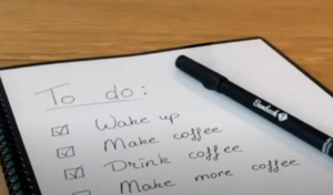 photo of a physical notebook with a to do list. A pen is sitting on top of the paper.